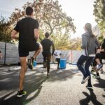 A diverse group of people enjoying outdoor activities in a park, representing a high quality of life.